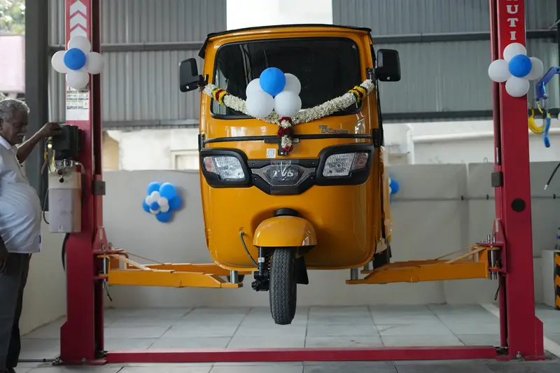 TVS King auto on a hydraulic lift in the Vijay TVS workshop